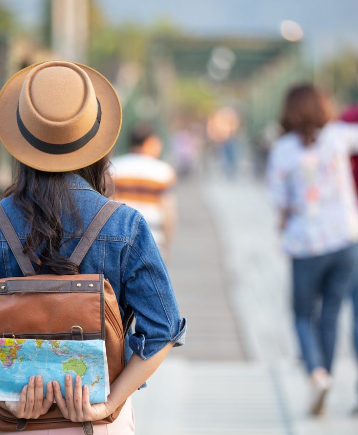 Female tourists on hand have a happy travel map.