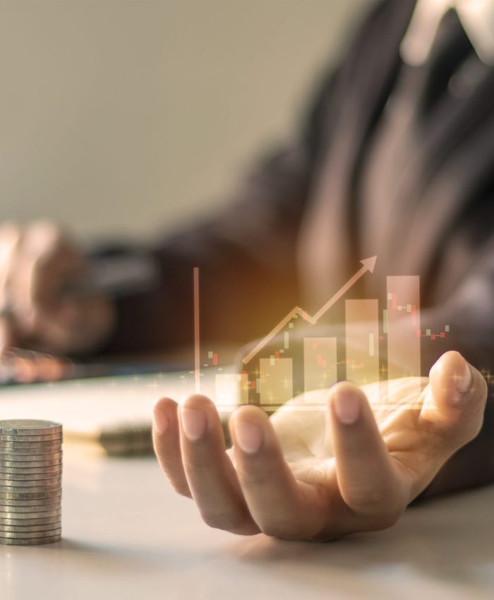 Financial growth graph on hand, business people are documenting office finance, financial ideas and loan investments.